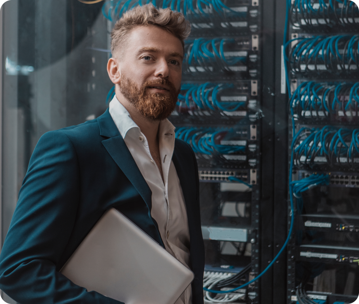 Man with laptop in server room